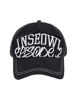 Black distressed baseball cap with white embroidered text and contrast stitching