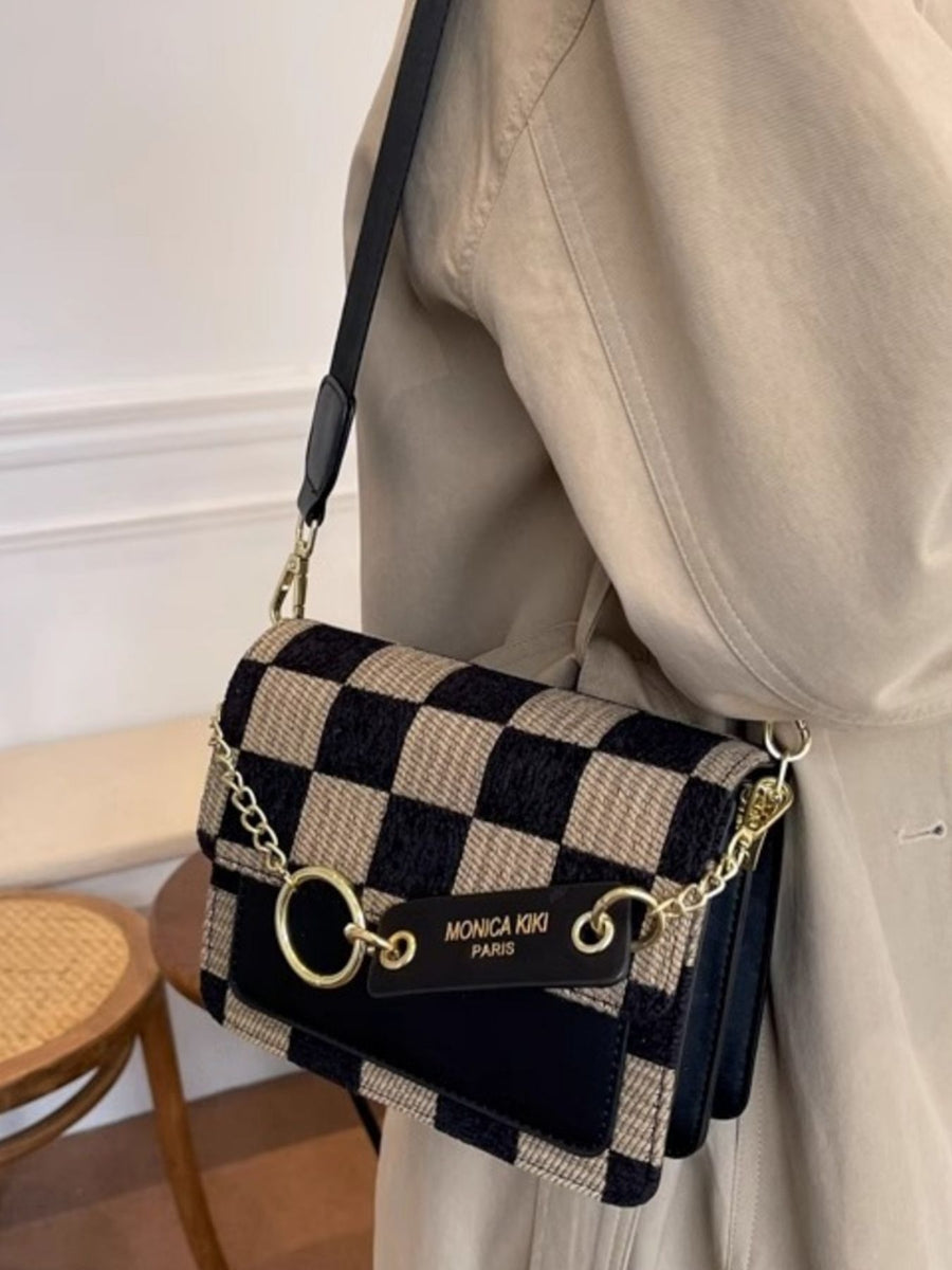 Mini checkered flap crossbody bag in beige and black with gold hardware and adjustable strap.