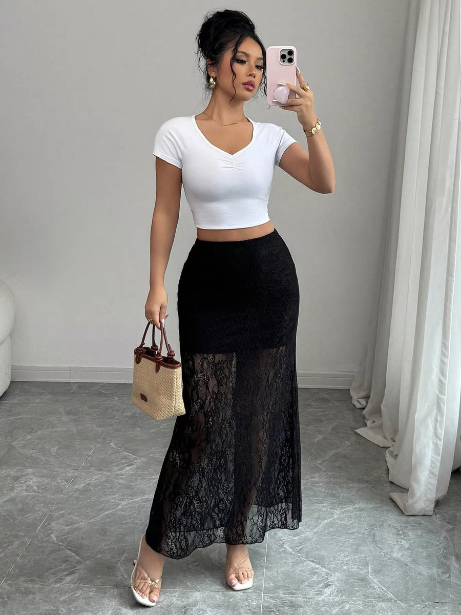Black lace maxi skirt with sheer lace overlay and lace trim hem.