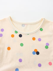Cream cotton toddler dress with colorful polka dots and a round neckline.