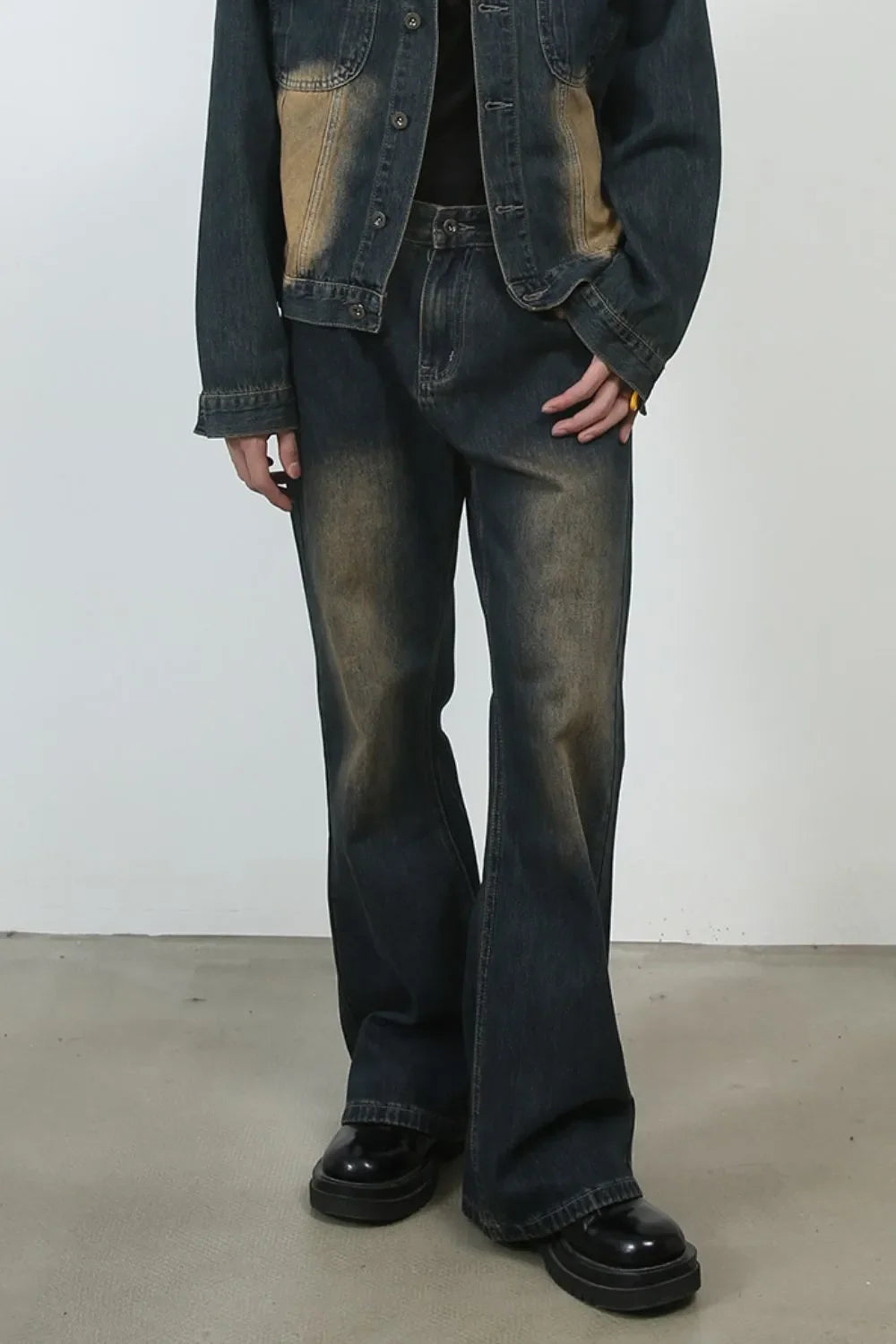 Dark faded denim flare jeans with a vintage wash and baggy fit.