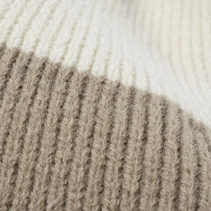 Colorblock knit beanie in cream and khaki with ribbed texture detail.
