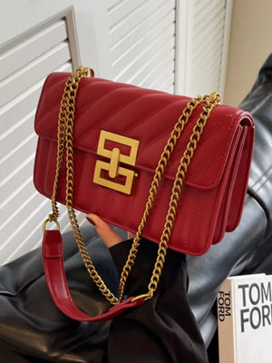 Chic quilted crossbody bag in wine red with gold chain strap and gold hardware.