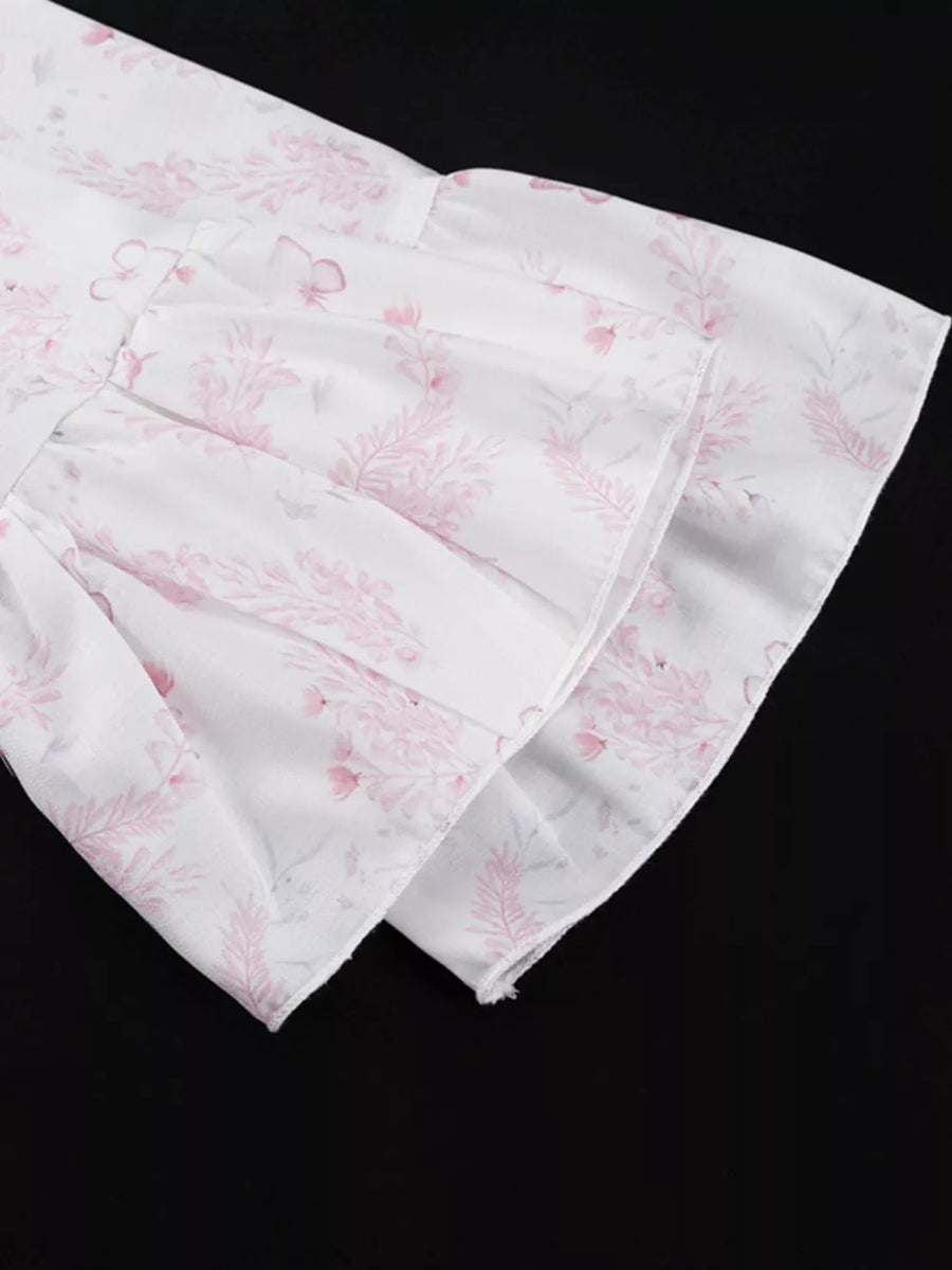 White dress with pink floral print and ruffled sleeves