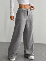 Grey corduroy wide-leg trousers with large front pockets and a relaxed fit.