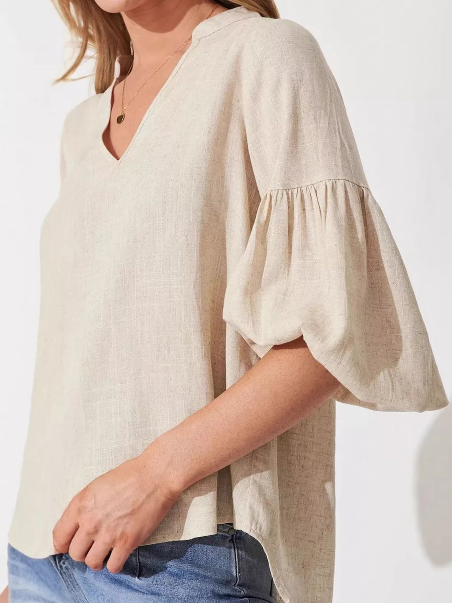 Maternity shirt in beige linen blend with notched V-neck and balloon sleeves.