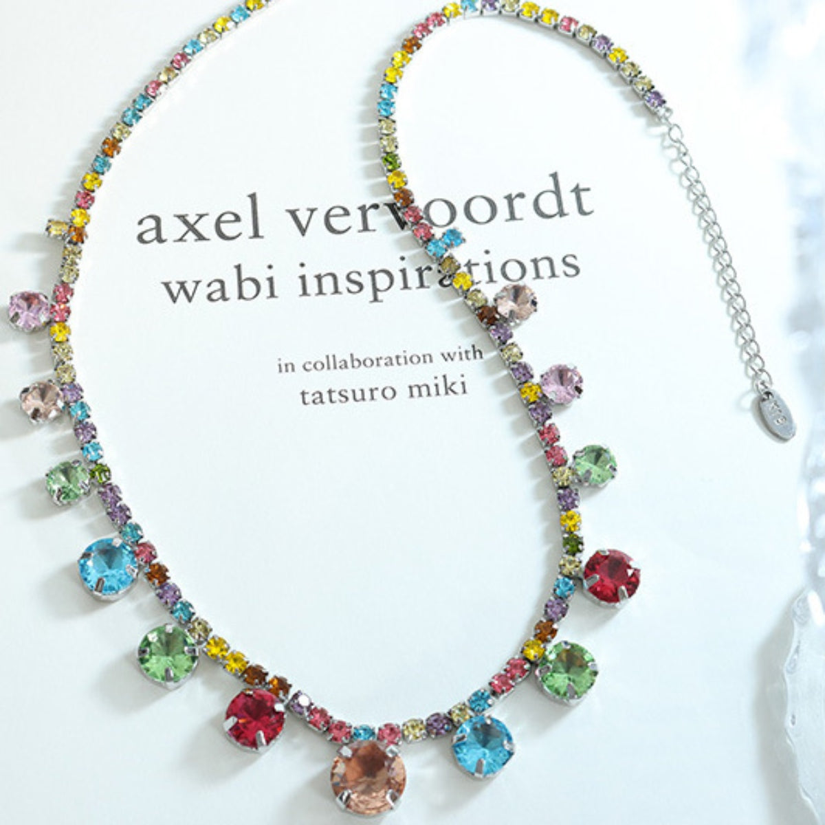 Rainbow gemstone cascade necklace with colorful dangling gems on a silver chain.