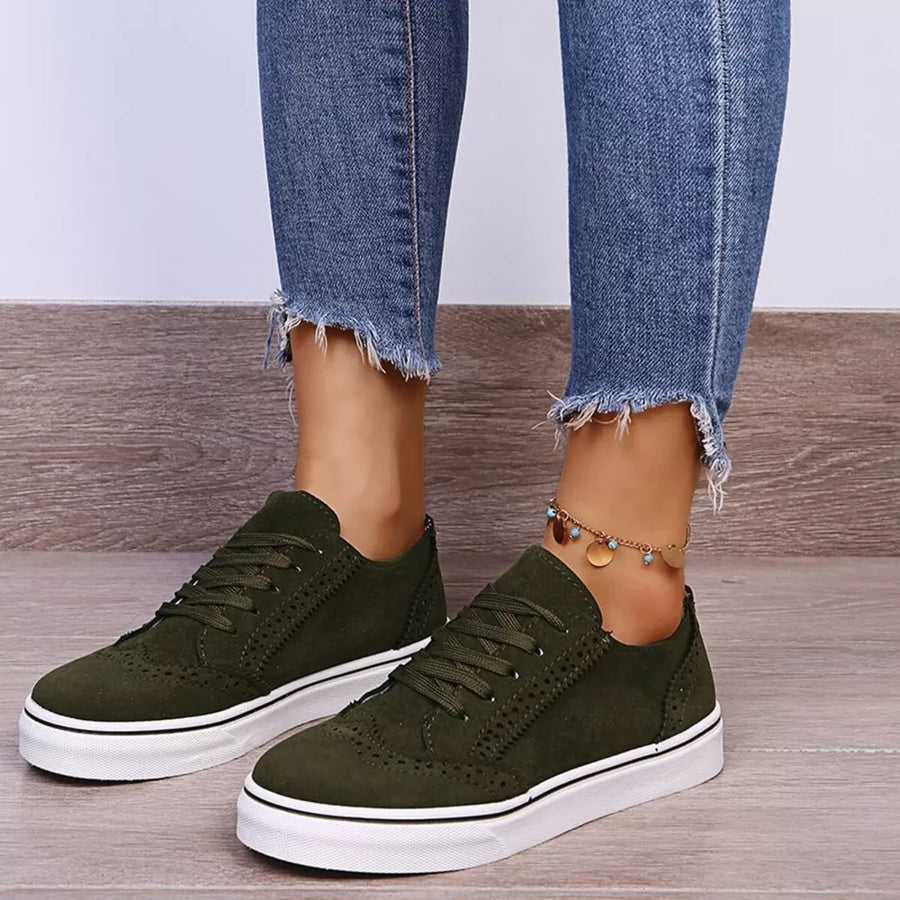 Green matte finish lace-up sneakers with white soles and brogue detailing.