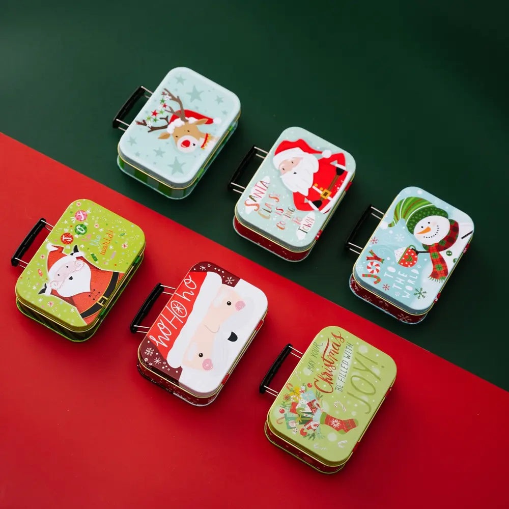 Festive illustrated tin boxes with Christmas designs, including Santa, snowman, and reindeer.