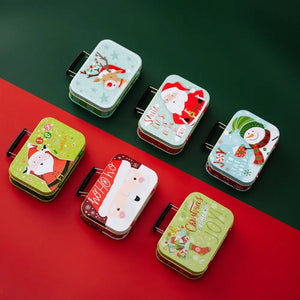 Festive illustrated tin boxes with Christmas designs, including Santa, snowman, and reindeer.