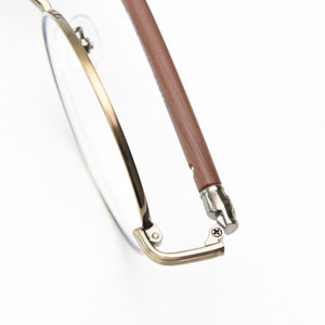 Round frame glasses with clear lenses, gold metal and brown acetate temples, and adjustable nose pads.