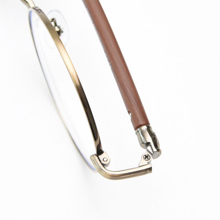 Round frame glasses with clear lenses, gold metal and brown acetate temples, and adjustable nose pads.