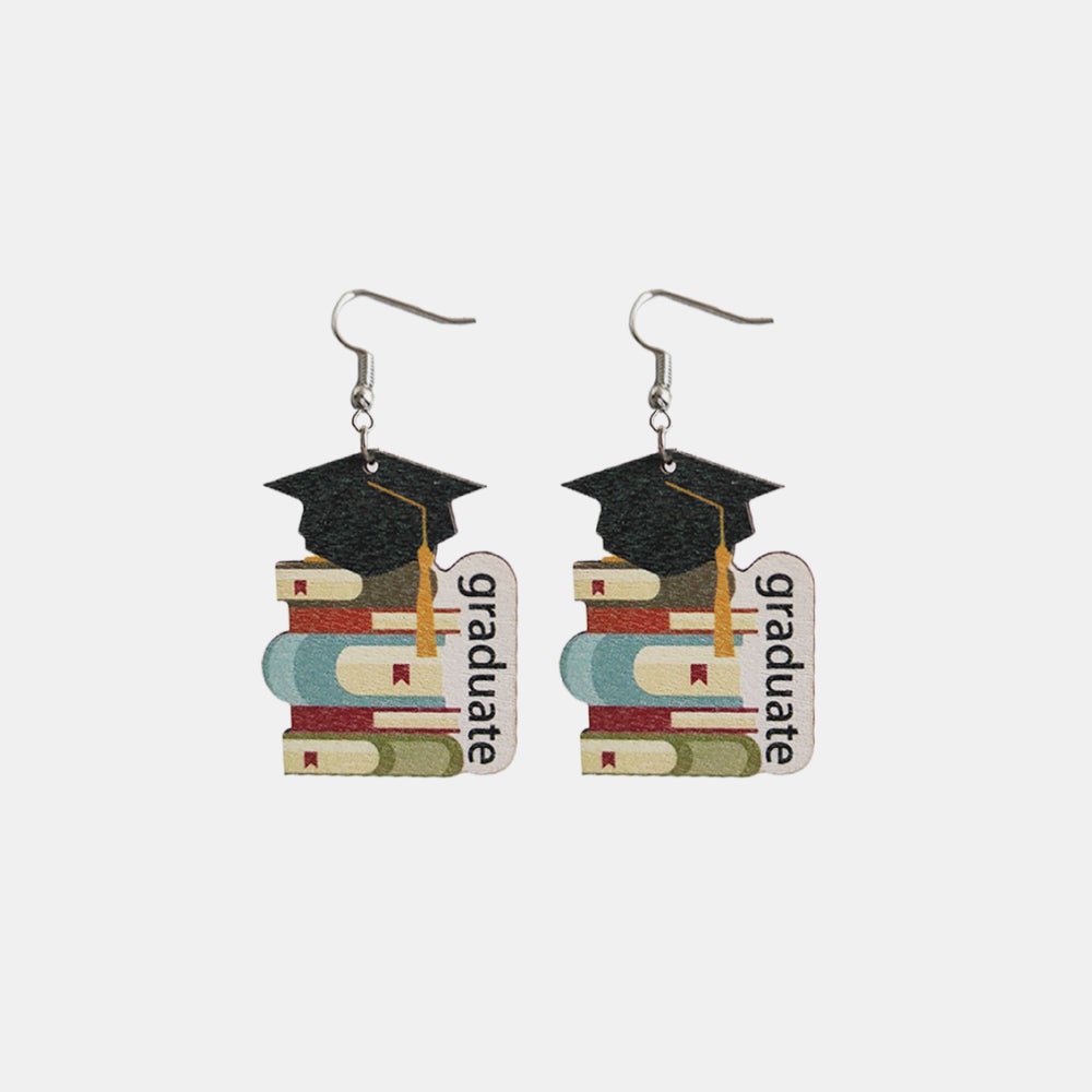 Graduation stacked book drop earrings with black caps and yellow tassels.