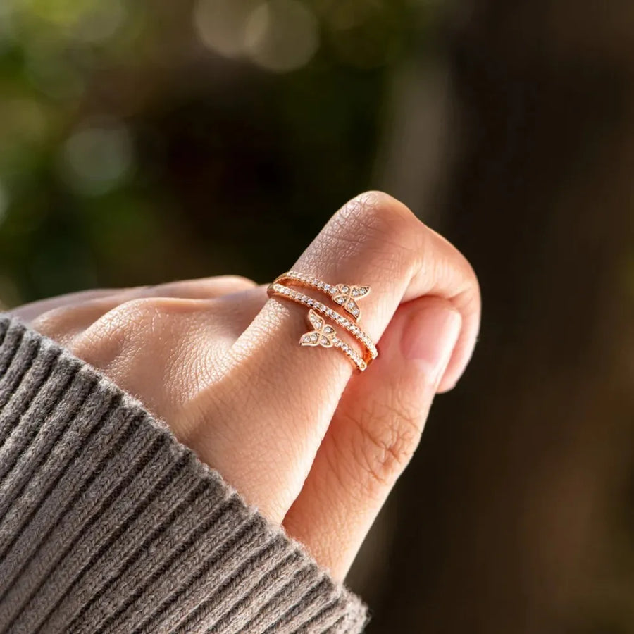 Gold bypass ring with two diamond-accented butterflies on a 18K gold-plated band.