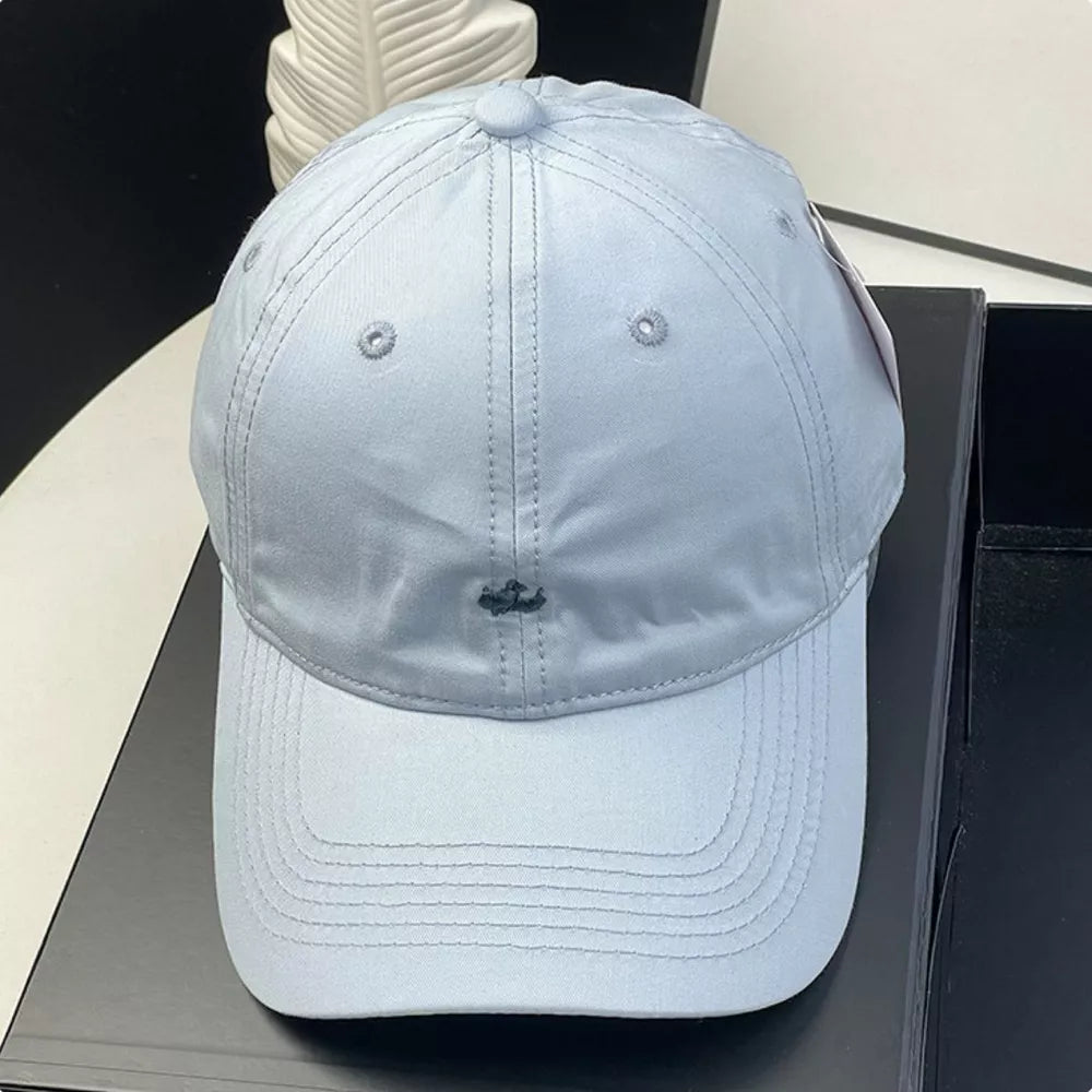 Sky blue cotton baseball cap with embroidered detail and ventilation eyelets