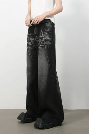 Dark wash wide leg jeans with sculpted details and a faded cat's whisker pattern.