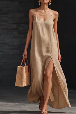 Khaki V-neck maxi dress with spaghetti straps and a high slit, styled with a straw tote bag.