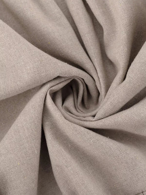 Light beige linen fabric with a textured weave, swirled to show drape.