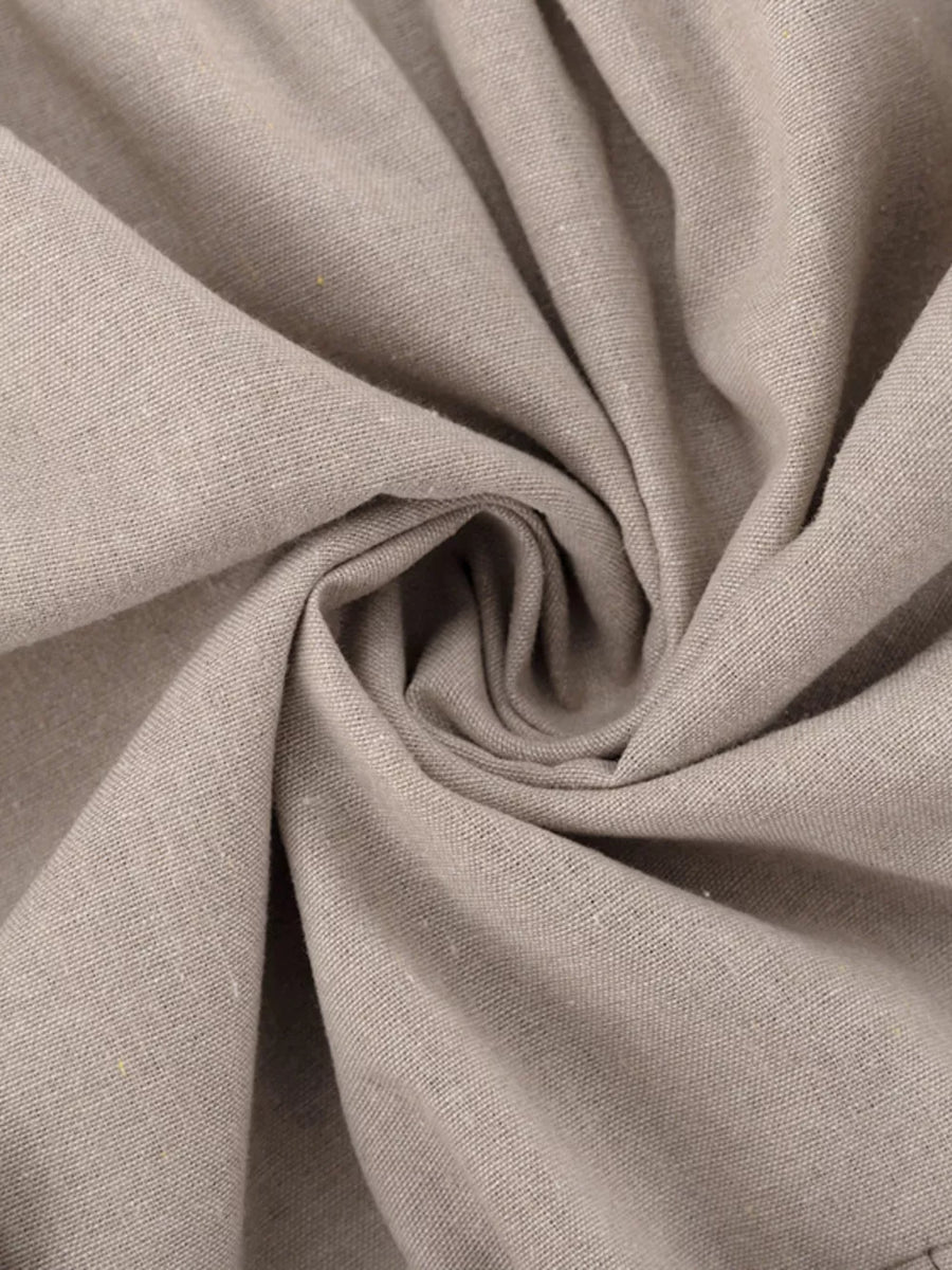 Light beige linen fabric with a textured weave, swirled to show drape.