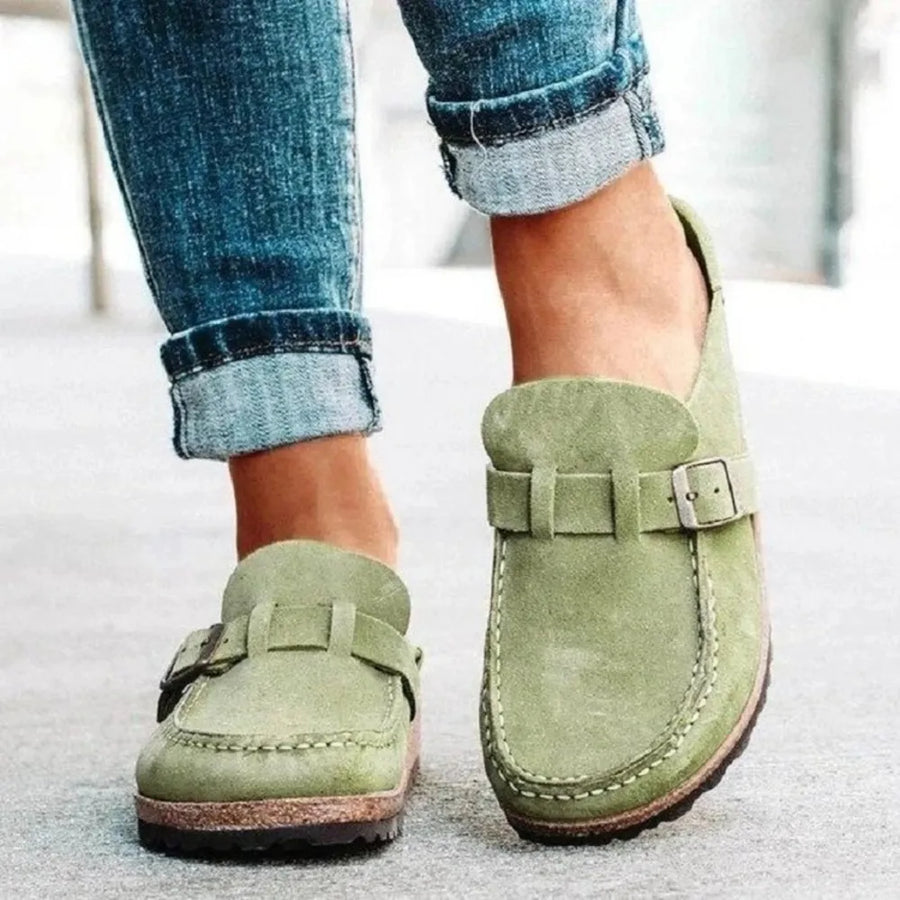 Sage suede buckle mule loafers with contrast stitching and buckle detail.