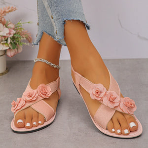 Pink floral embellished comfort slingback sandals with cross straps.