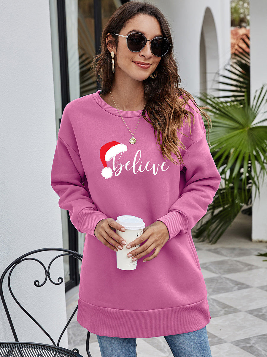 Christmas graphic tunic sweatshirt in Dusty Pink with "Believe" and Santa hat graphic, crewneck, long sleeves.