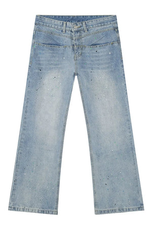 Light wash denim jeans with double waistline and splatter paint detail.