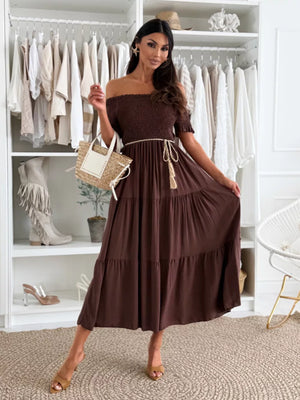 Dark brown smocked off-shoulder midi dress with tiered skirt and tassel belt.