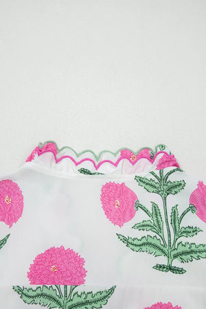White cotton blouse with vibrant pink floral print and scalloped pink and green trim neckline.
