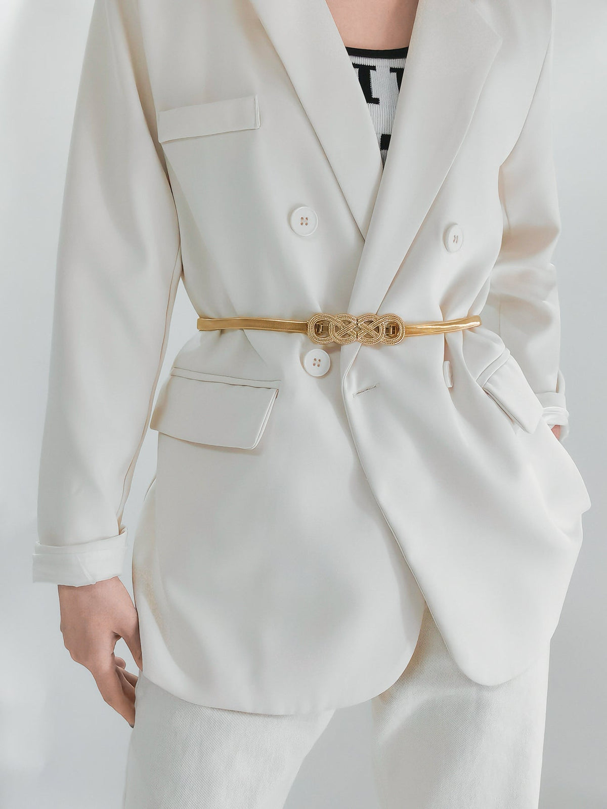 Gold intertwined knot metal waist belt with a textured buckle detail.