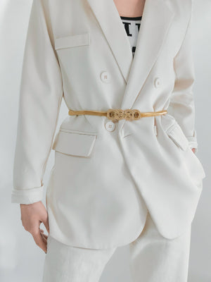 Gold intertwined knot metal waist belt with a textured buckle detail.