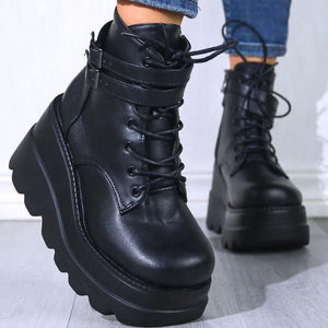 Black platform buckle lace-up booties with chunky soles and side zippers.