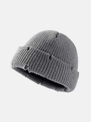 Gray ribbed knit beanie with distressed details and a cuffed brim.