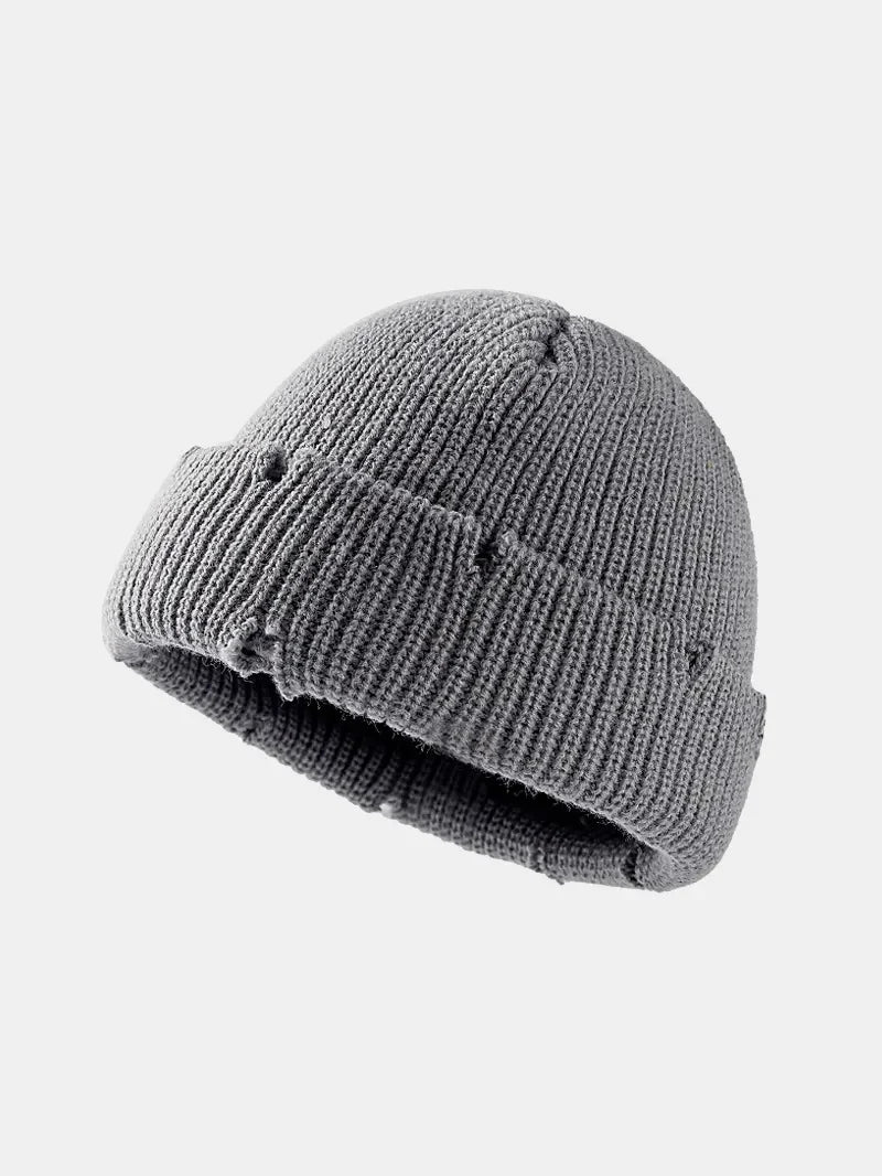 Gray ribbed knit beanie with distressed details and a cuffed brim.
