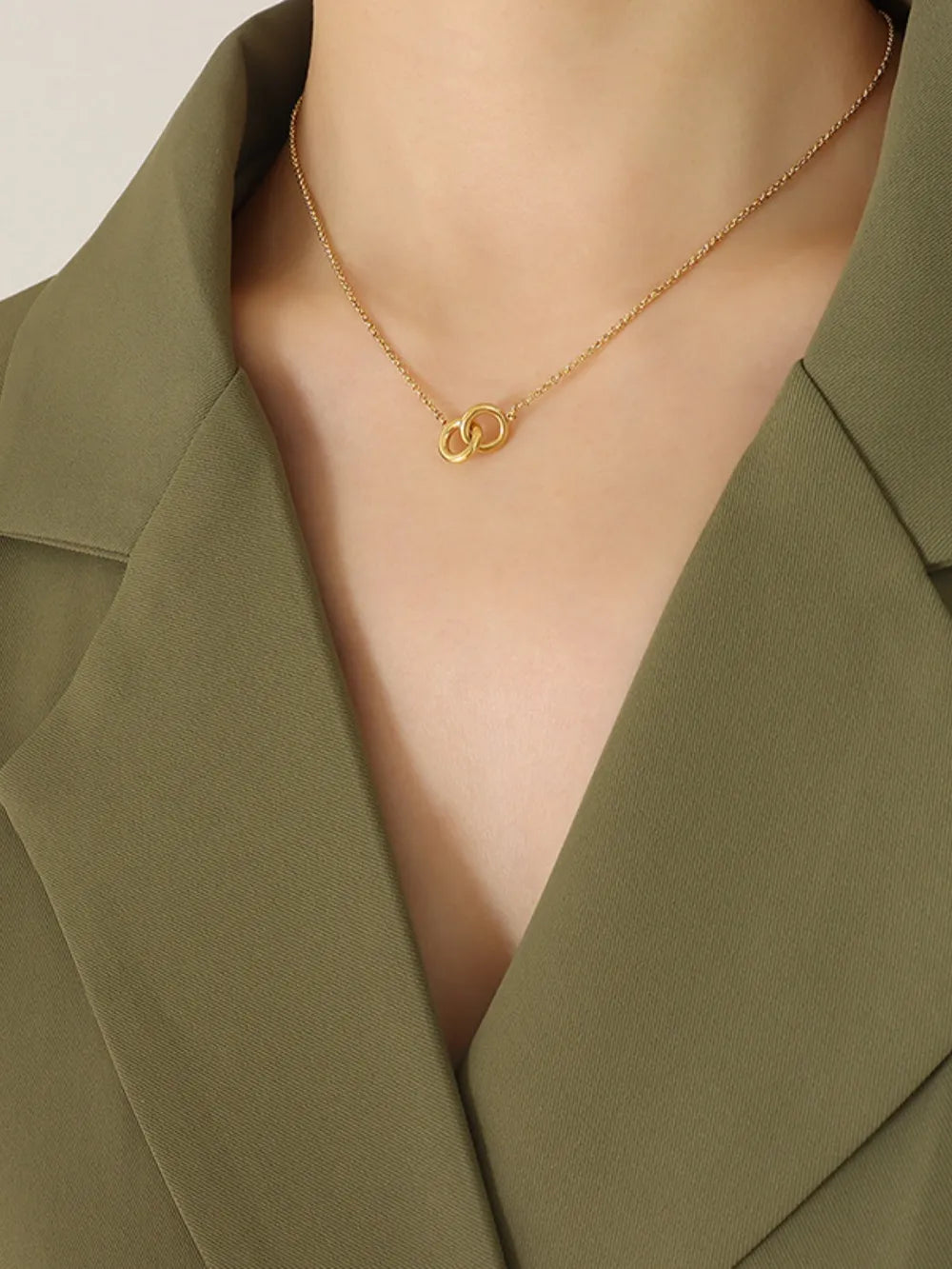 Gold interlocked circle pendant necklace with a delicate chain.