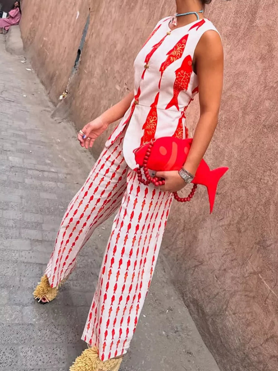 Red fish print sleeveless top and wide-leg pants set with gold button details.