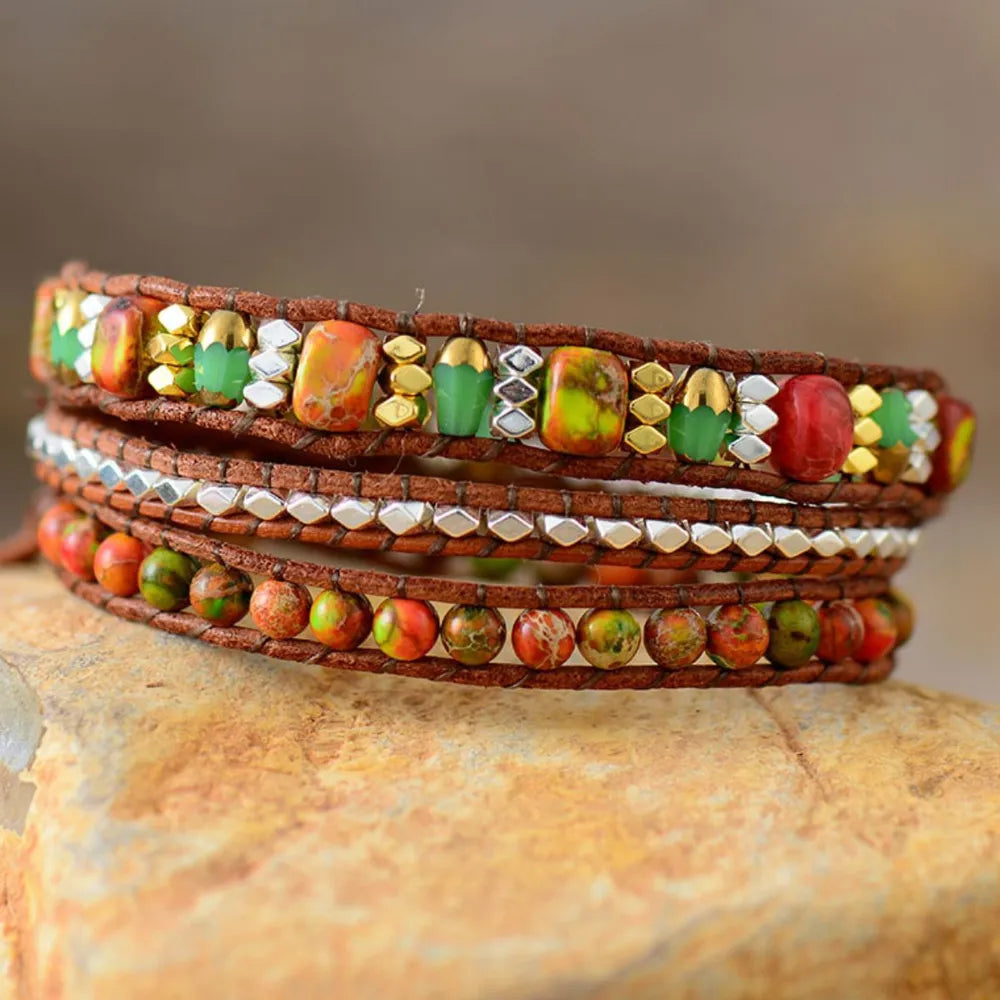 Orange wrapped leather bracelet with mixed gemstone beads and silver accents.