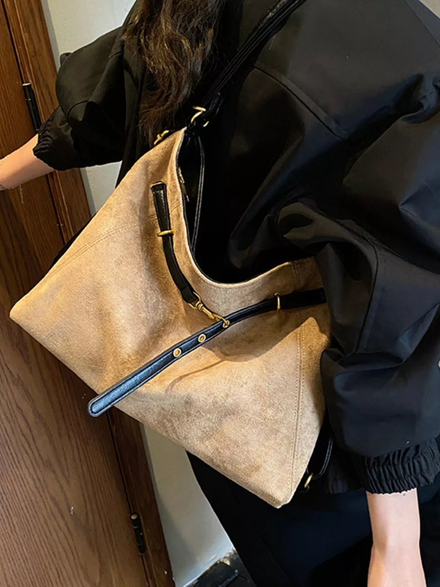 Khaki suede large tote bag with black trim and gold hardware.