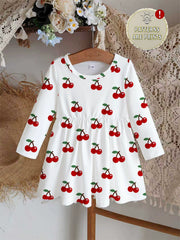 White long sleeve baby dress with allover red cherry print and gathered waist