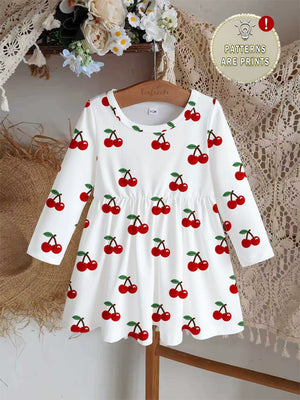 White long sleeve baby dress with allover red cherry print and gathered waist