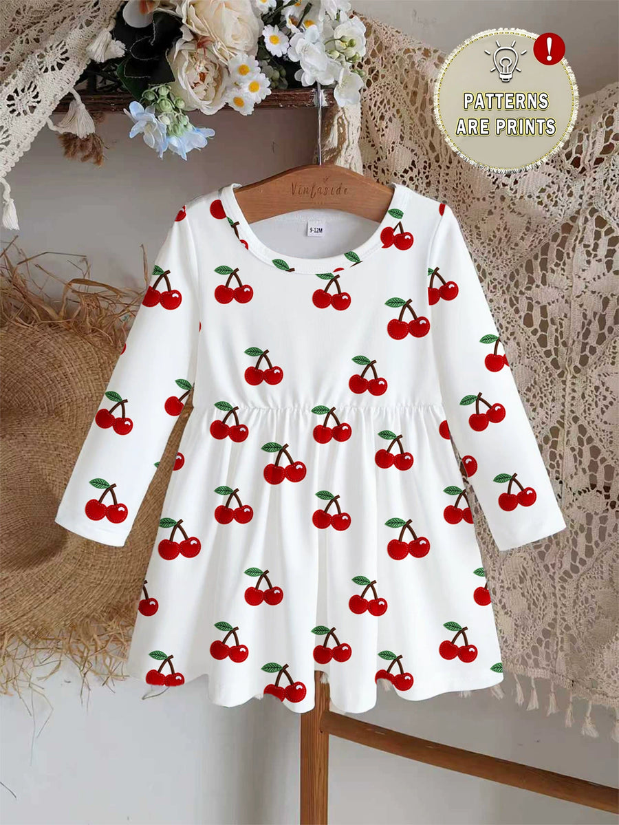 White long sleeve baby dress with allover red cherry print and gathered waist