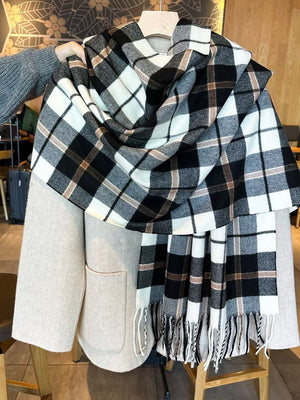 Plaid fringe scarf in black, white, and taupe with tasseled ends.