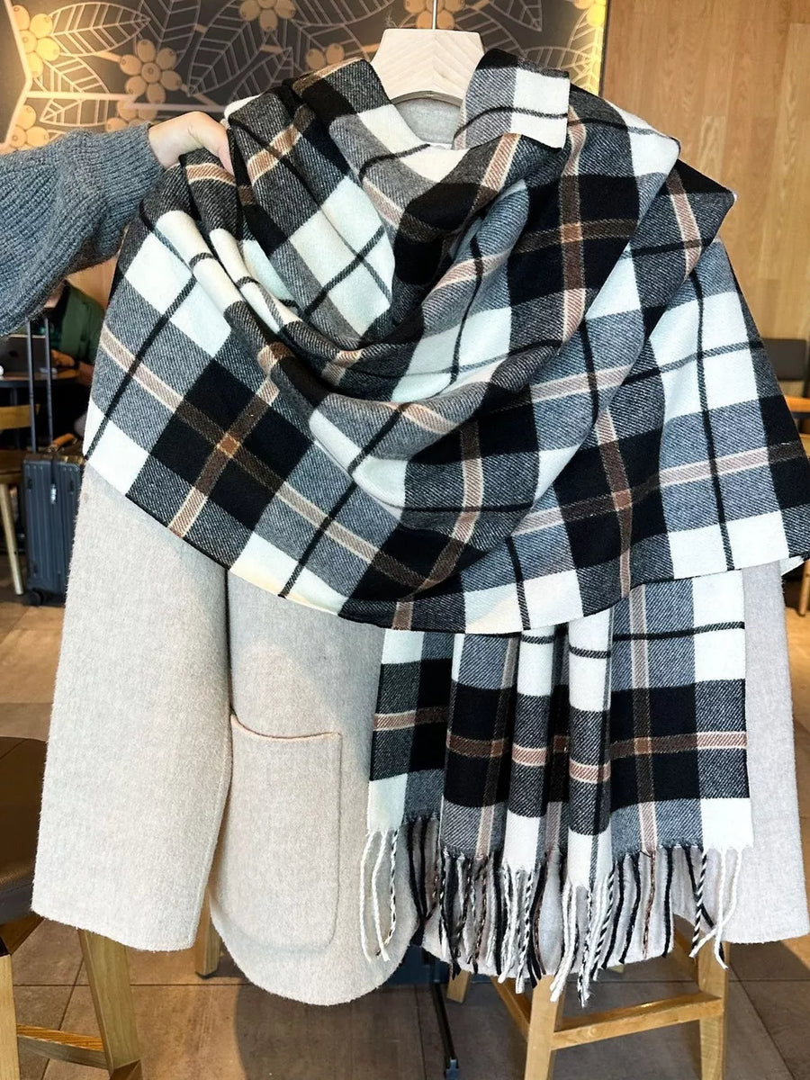 Plaid fringe scarf in black, white, and taupe with tasseled ends.