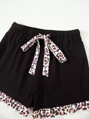 Black pajama shorts with leopard trim and drawstring waist.