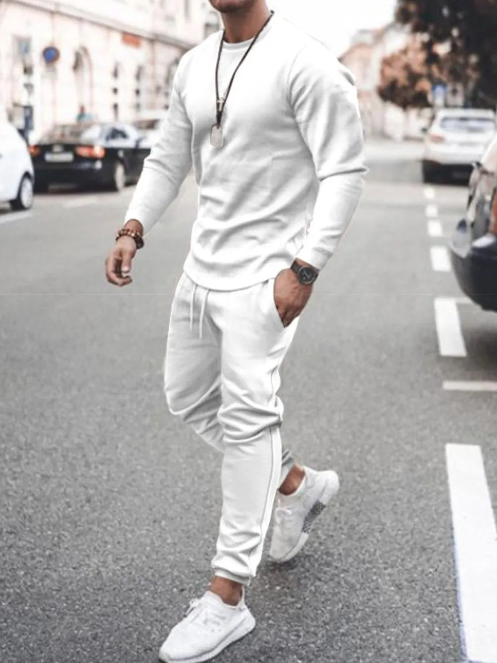 Men's white textured loungewear set with crewneck sweatshirt and drawstring pants.
