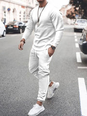 Men's white textured loungewear set with crewneck sweatshirt and drawstring pants.