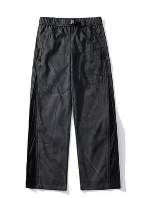 Black utility-inspired wide-leg joggers with mesh side panels and buckle belt.