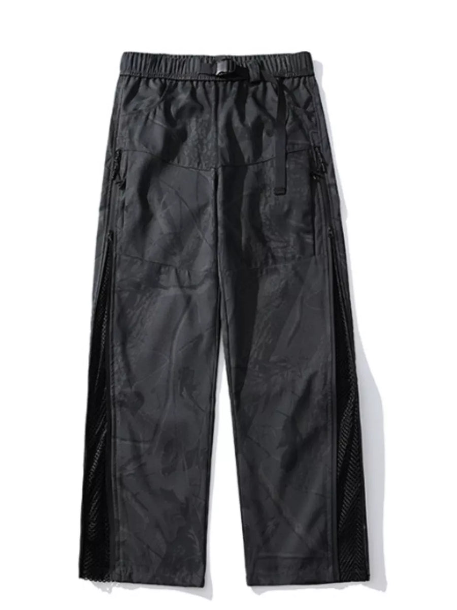 Black utility-inspired wide-leg joggers with mesh side panels and buckle belt.
