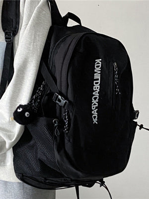 Black nylon casual backpack with zippered pocket and mesh side pocket.
