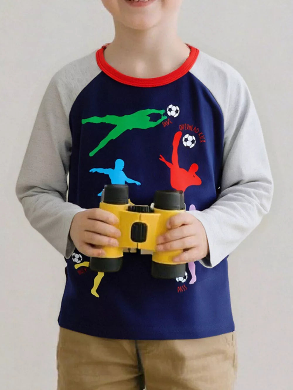 Navy long sleeve cotton tee with colorful soccer graphic and red neckline.